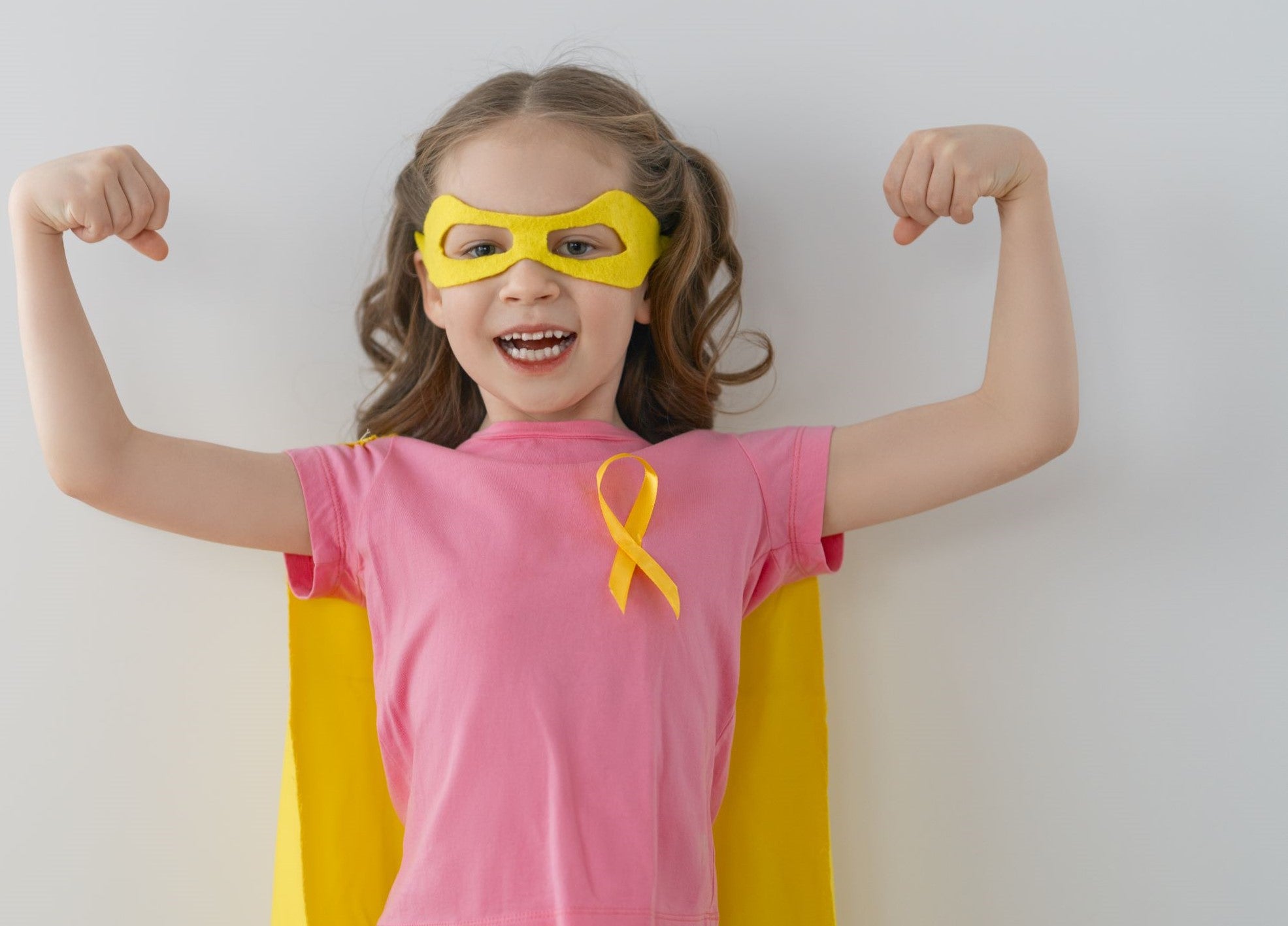 Girl with cancer showing her strength with arms in strong position